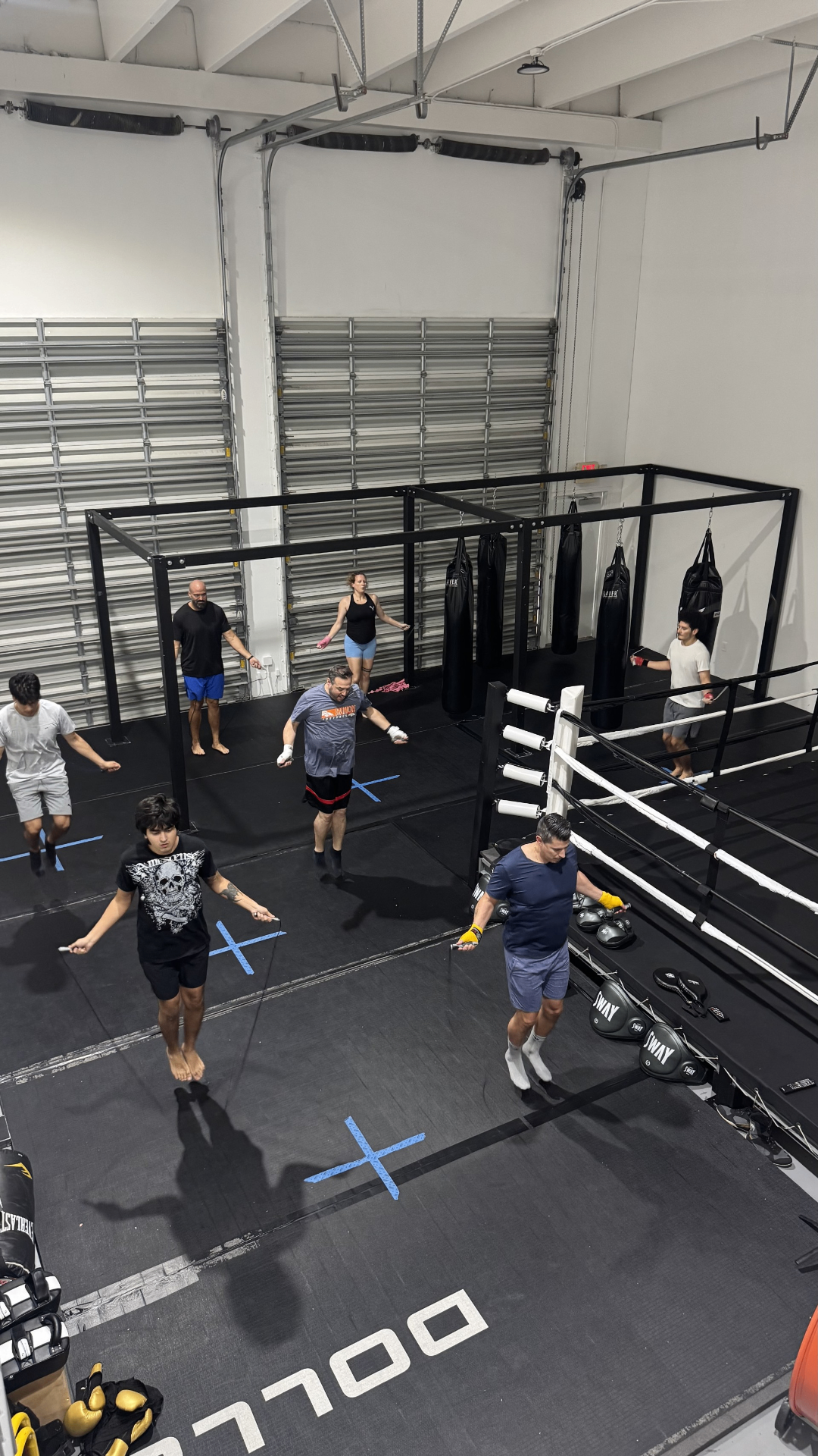 Group class jumping rope beside the ring at Thaitan Boxing Club